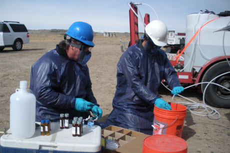 U.S. Environmental Protection Agency staff members sample a monitoring well for contaminants from hydraulic fracturing