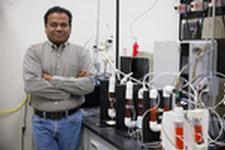 Pratap Pullammanappallil, a UF associate professor of agricultural and biological engineering, poses with an anaerobic digester used in a process he developed at NASA’s request to turn human waste into rocket fuel.