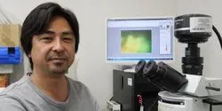 Associate Professor Yohey Suzuki at the Microscope with Rock Sample