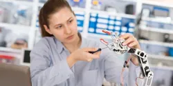 young student working on robotic arm
