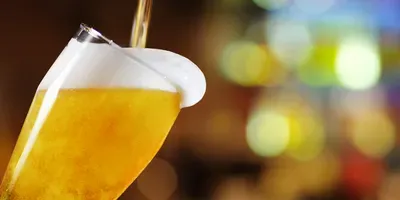 beer being poured into a glass
