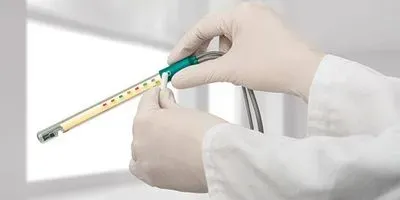 Hands holding a glass tube