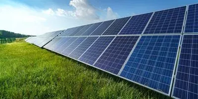 solar panels in a bright green field