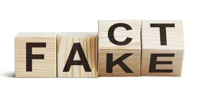 Wooden blocks shifting from the word fact to fake