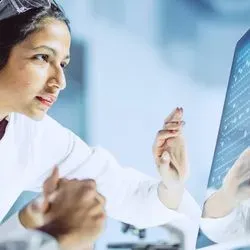 Two researchers looking at a monitor