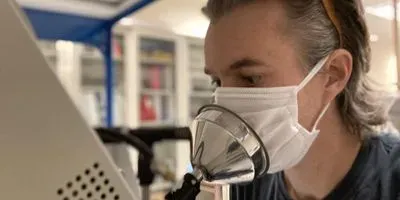 Man Coughing through a mask intoa sensor
