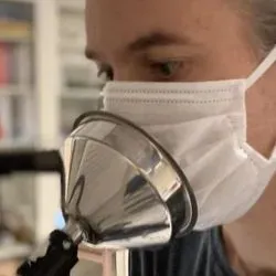 Man Coughing through a mask intoa sensor