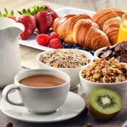 Image of coffee, croissants, and fruits