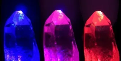 Image of quartz crystals under illumination with strong laser fields of different coloured light (red and blue), and both colours added together (middle).
