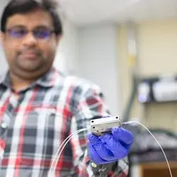 Chemical and biomolecular engineering graduate student Saket Bhargava holds a flow electrolysis cell