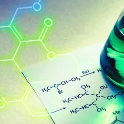 Image of a beaker on some chemical equation notes