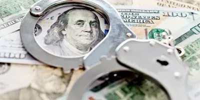 Image of handcuffs on money