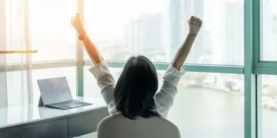 Image of woman working and celebrating 