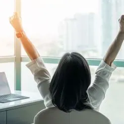Image of woman working and celebrating 