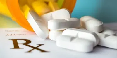 Pills falling out of a pill bottle