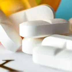 Pills falling out of a pill bottle