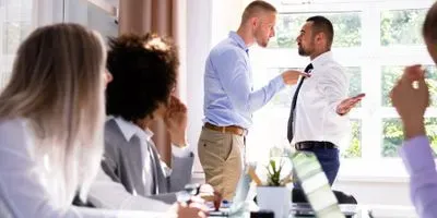 Two men having a fight at work