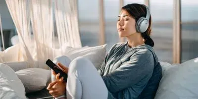 Image of young woman relaxing and listening to music