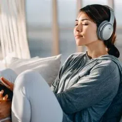 Image of young woman relaxing and listening to music