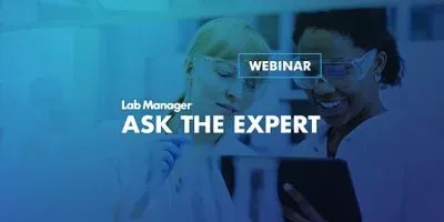 Lab experts working together and reviewing work on a tablet