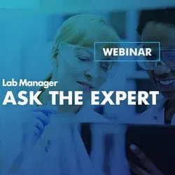 Lab experts working together and reviewing work on a tablet