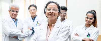 Woman standing with arms crossed in front of staff