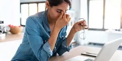 Women stressed at her computer at home
