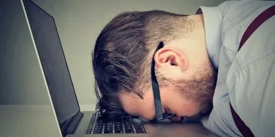 Man slamming head on laptop