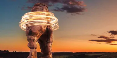 A rock formation in the desert surrounded by light rings.