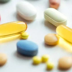 Numerous different pills laid on a white table