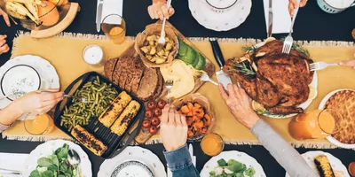A family eating a large meal over the holidays, seen from above