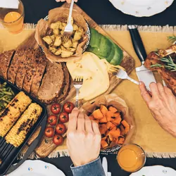 A family eating a large meal over the holidays, seen from above