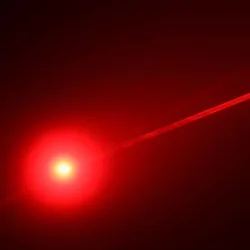 A red light laser on a black backdrop