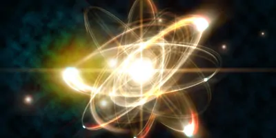 Electrons orbiting a nucleus made of light on a black background