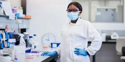 female scientist in lab in strong pose