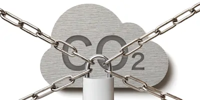 The words CO2 carved on a metal plate, locked behind chains and a padlock