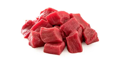 Chunks of raw beef on a white background