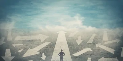 Person with hands on hips, standing in a space with arrows point in different directions 