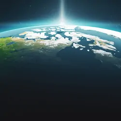 View, from space, of the sun rising behind the earth