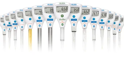Numerous pH meters on a white background