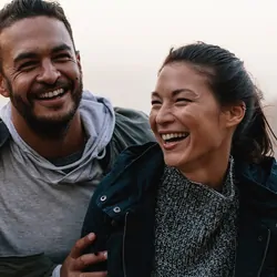 Man and women smiling while on a hike