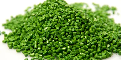 Green plastic pellets on a white background.