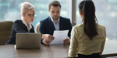 Women being interviewed by a panal for a job