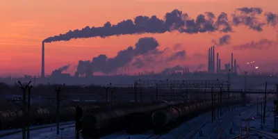 Smoke stacks in the background emitting smoke into the air