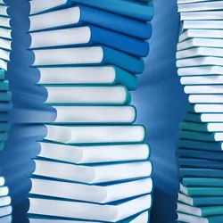 Books pilled into a helix like shape on a blue background