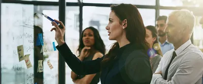 Female leader demonstrating process to staff