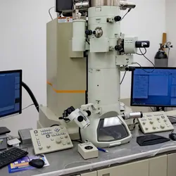 A transmision electron microscop on a desk with computers in a lab