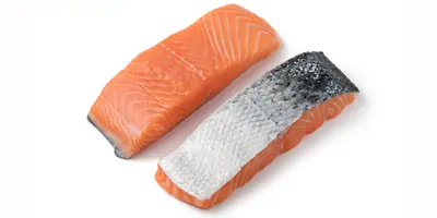 Raw salmon portions on a white background