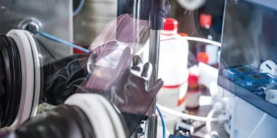 Researcher Preparing Samples in Glove Box for Measuring Transient Photocurrent in Organic Semiconductors.