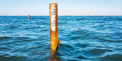 A pole for measuring sea level, in the ocean